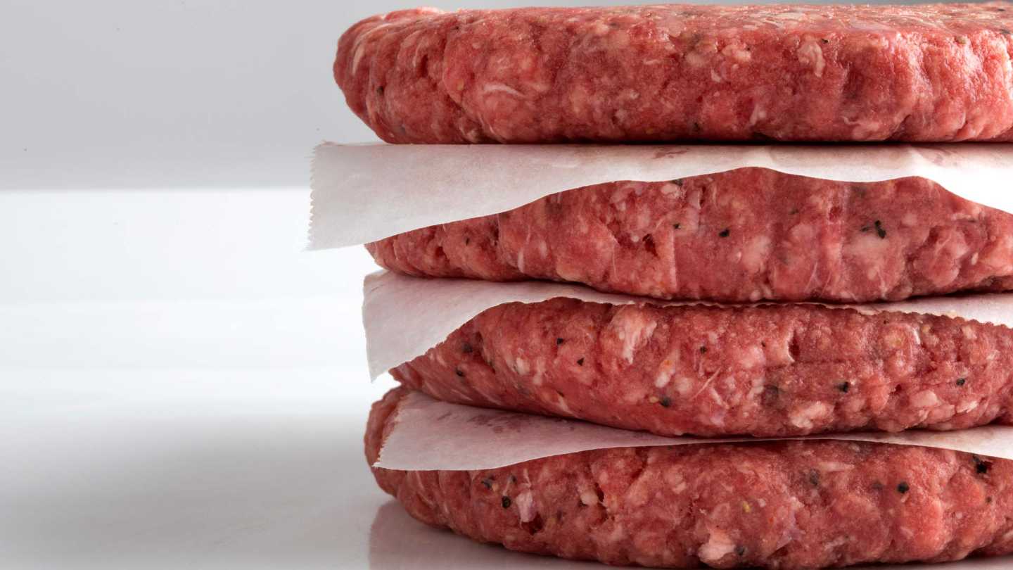 Single Stack of Four Raw Beef Patties with Paper Liners